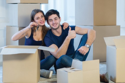 Man and van service preparing for a Docklands flat move near modern apartment buildings