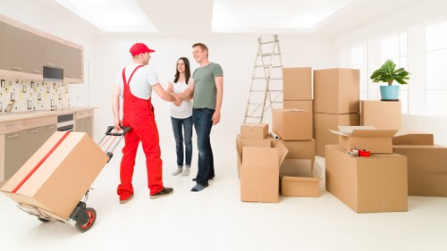 A moving team unloading items at a Docklands property entrance