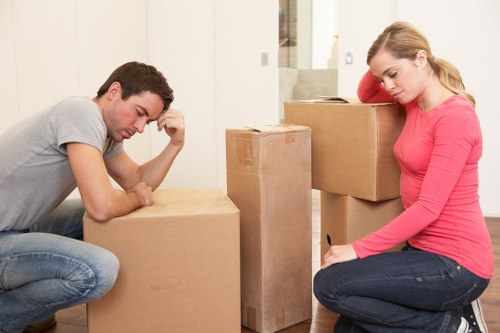 Trained removal staff using PPE while lifting household items