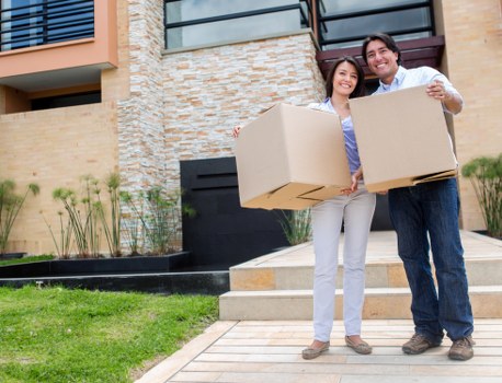 Local removalists handling furniture in a Docklands high-rise building